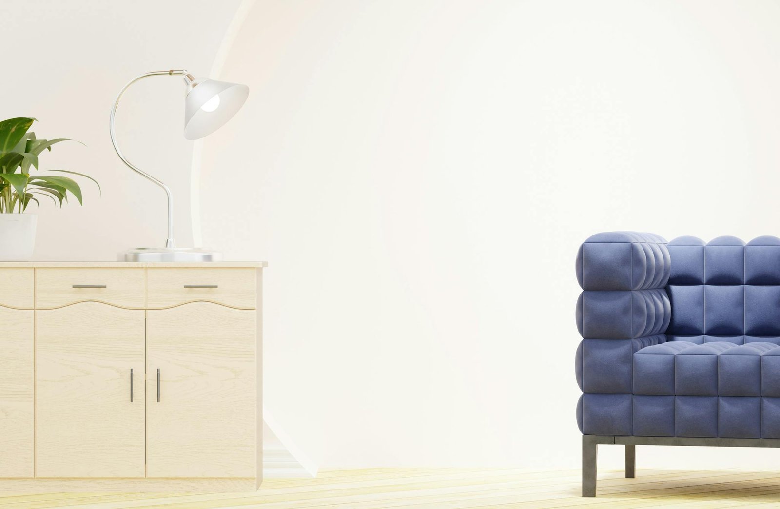 Bright modern living room featuring a stylish blue sofa and light wood cabinet with decor.