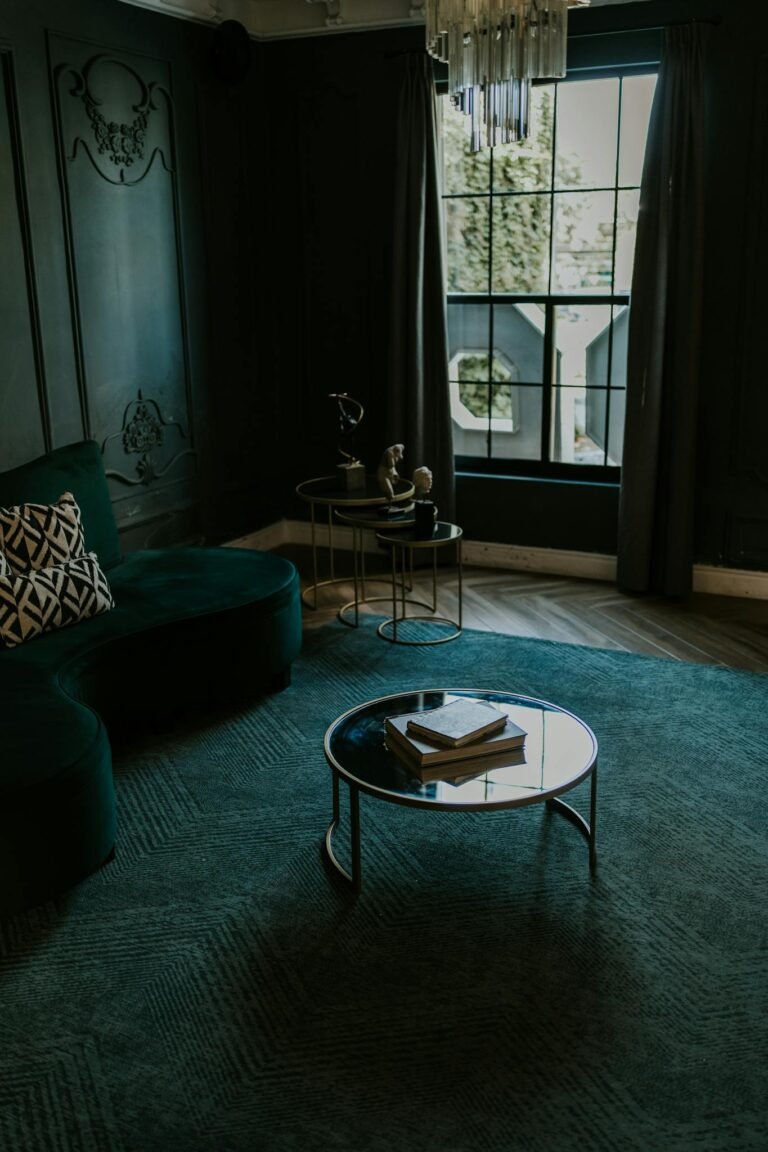 Chic dark living room featuring a velvet sofa and vintage decor accents.