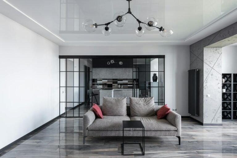 Elegant living room featuring a sleek grey sofa and contemporary design elements.